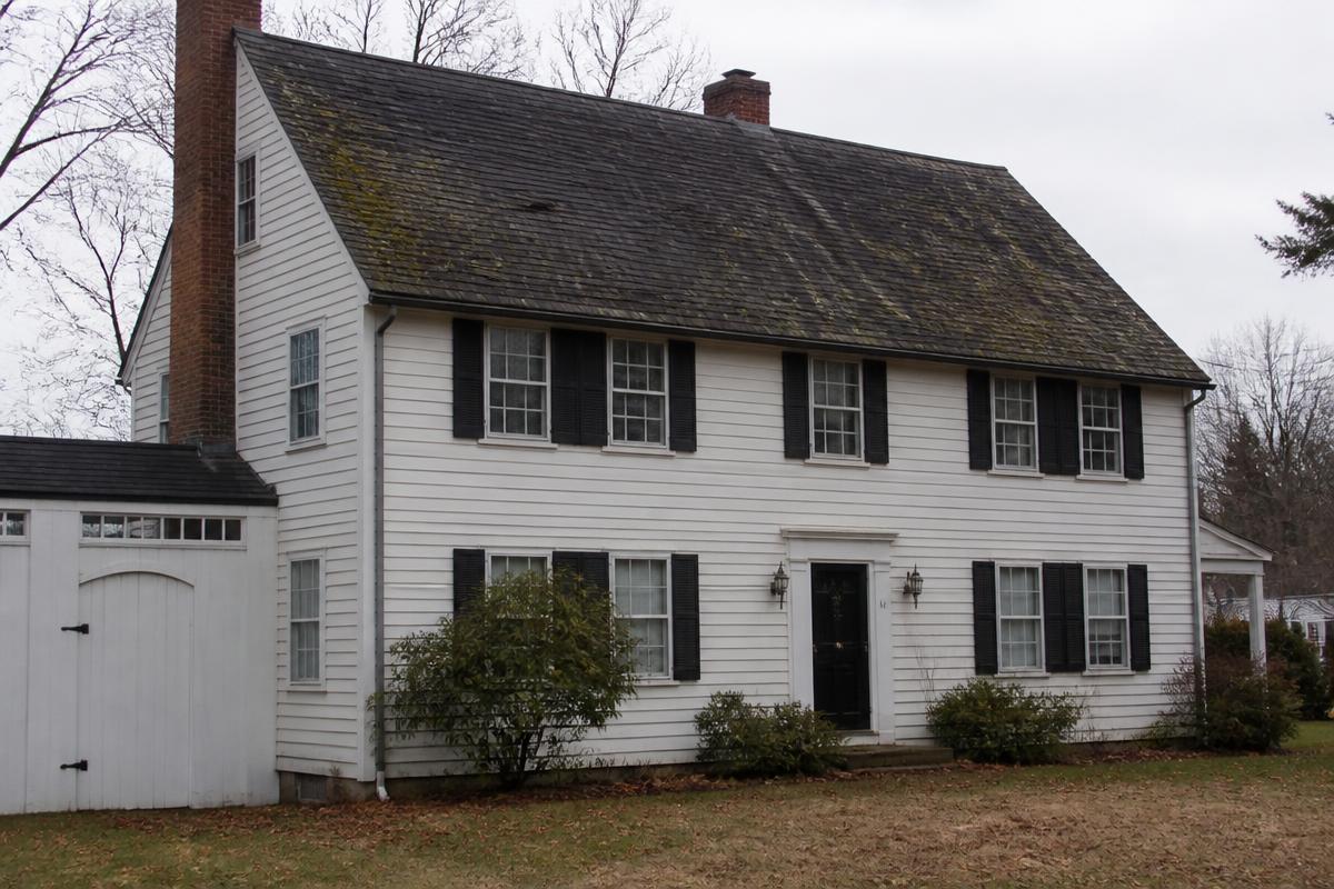 Connecticut colonial with a worn, curling asphalt shingle roof before replacement