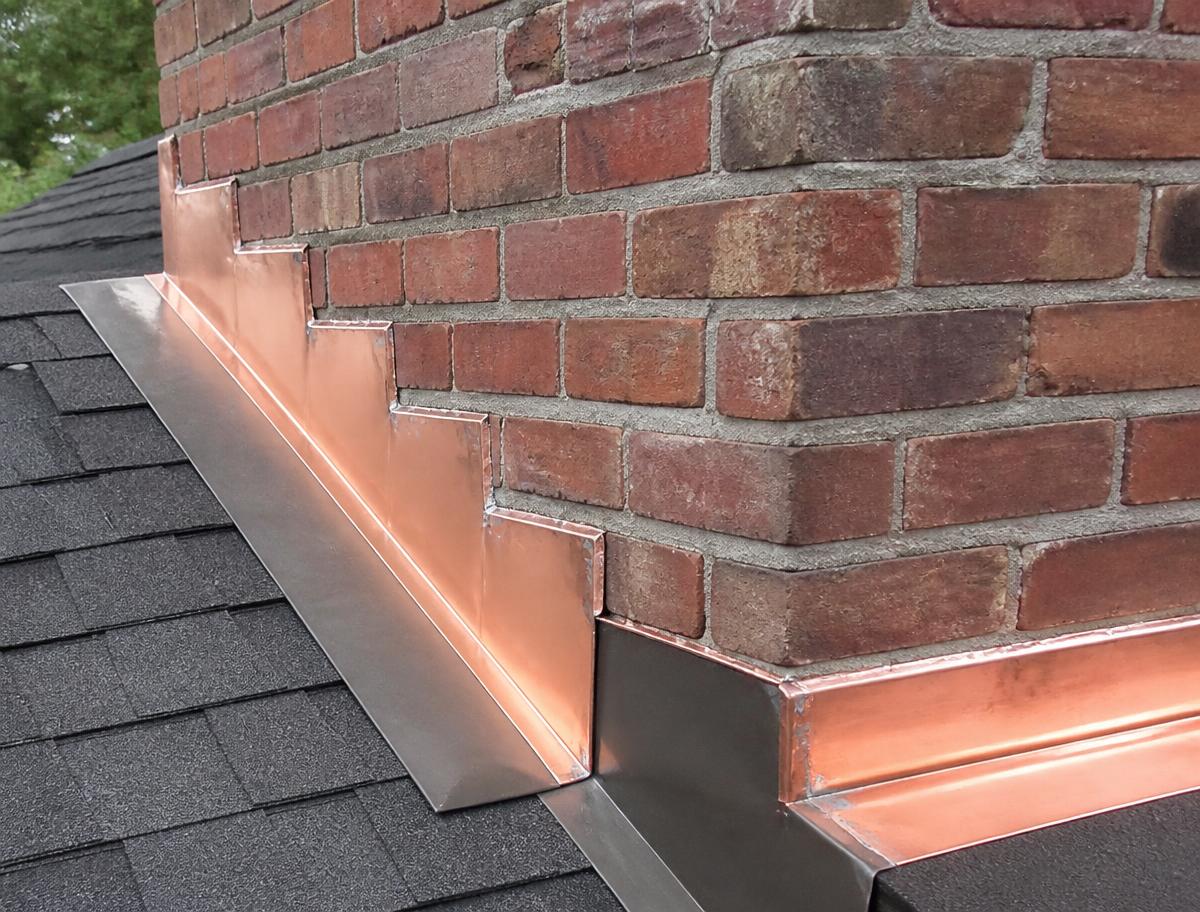 New copper step and counter-flashing at a brick chimney